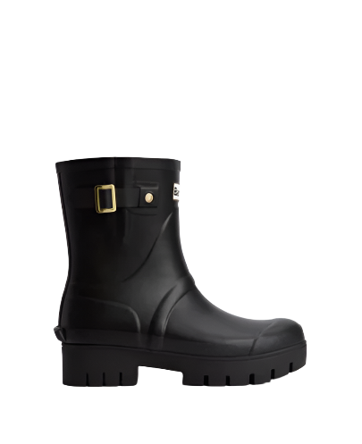 Calf-height black rubber boots with adjustable buckle at the ankle and a Barbour logo plaque, on a white background.