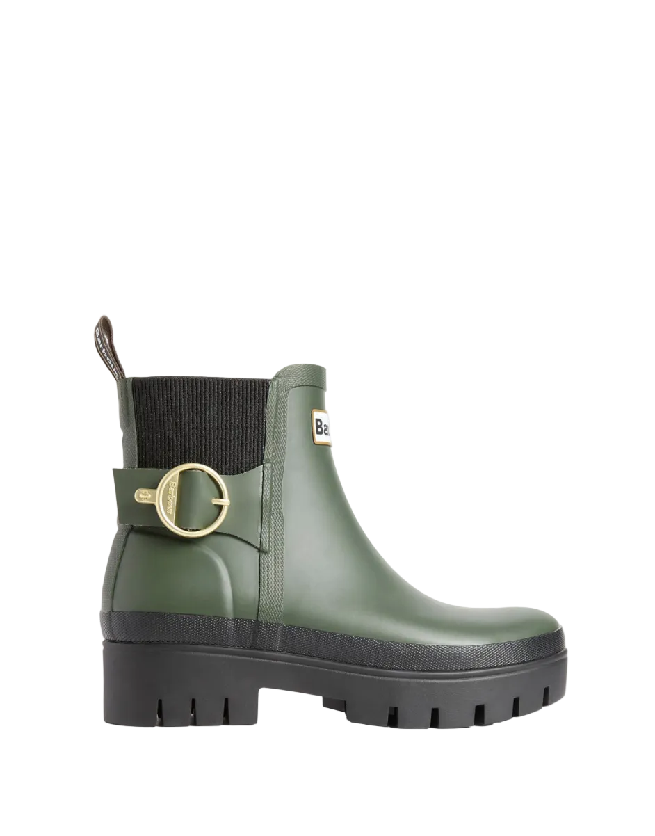 An olive green rain boot with a chunky black sole and heel, featuring a black elastic side panel, a gold-tone buckle detail, and a small white brand tag on the side.