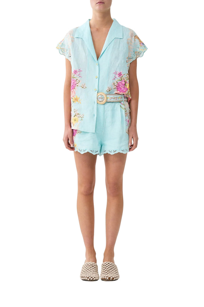Light blue romper with floral embroidery on a white background