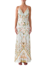 Woman wearing a floral and graphic patterned dress on a white background