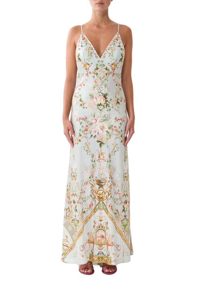 Woman wearing a floral and graphic patterned dress on a white background