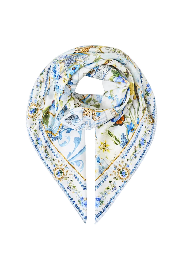 A square silk scarf with an intricate multicolor print featuring blue and yellow floral motifs, gold borders, and a central tiger design, displayed on a clean white background.