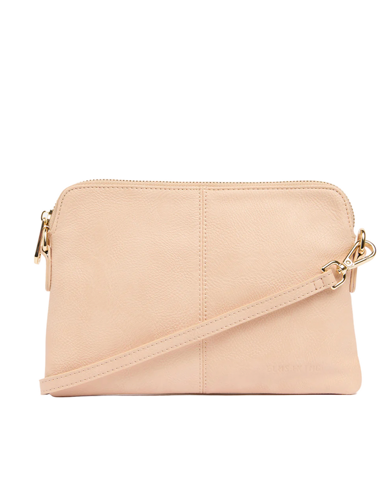 Beige crossbody bag with gold zipper on a white background