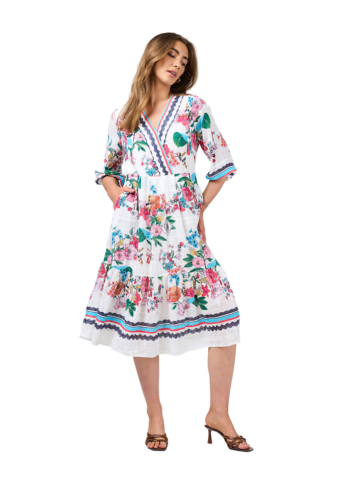 Woman wearing a floral dress against a white background