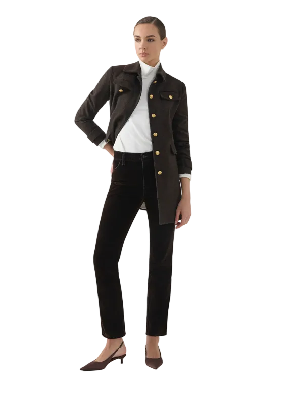 Woman wearing a black jacket with gold buttons, white shirt, and black pants on a white background