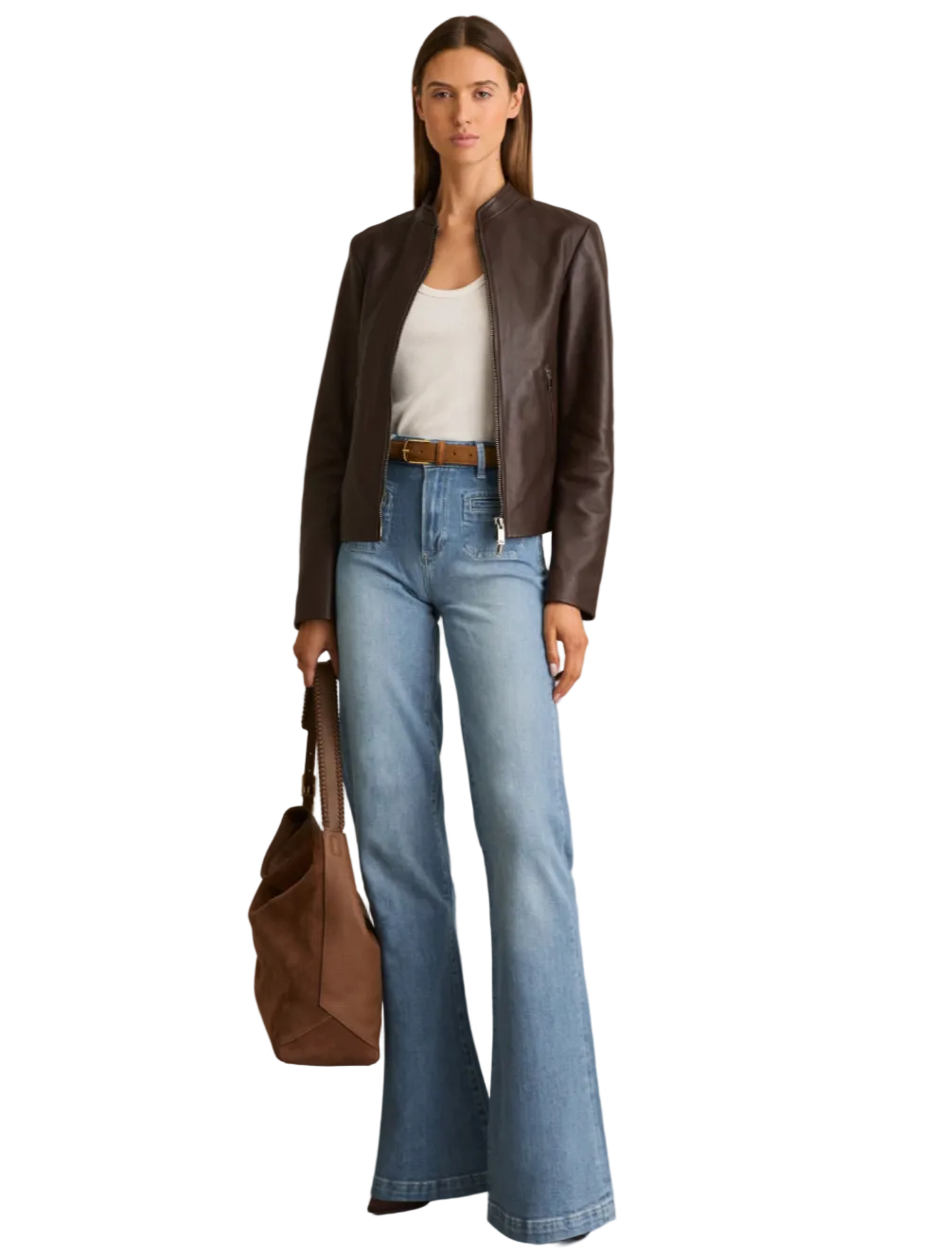 A woman modeling a dark brown leather jacket, light-wash blue flared jeans, a white top, a brown belt, and carrying a brown leather tote bag against a plain white background.