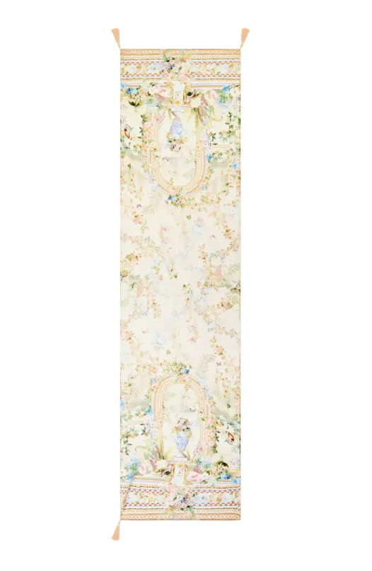 A long decorative wall hanging or tapestry with an ornate pastel floral and scroll pattern, shown flat against a light gray background. The top and bottom edges have tassels, and a small 'NEW ARRIVAL' label appears in the top-right corner.